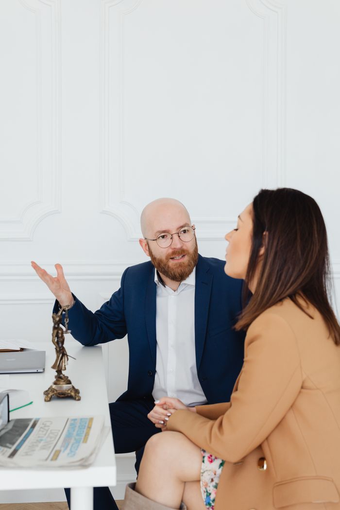 A lawyer and client in a professional office setting discussing legal matters.